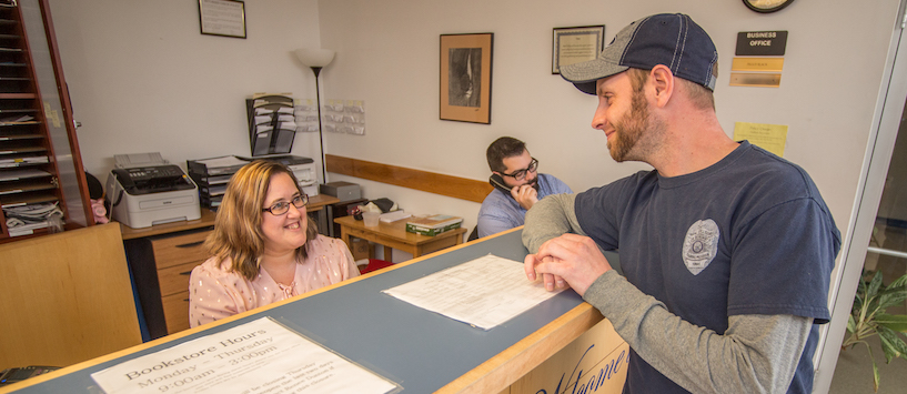 A student talking with front desk staff